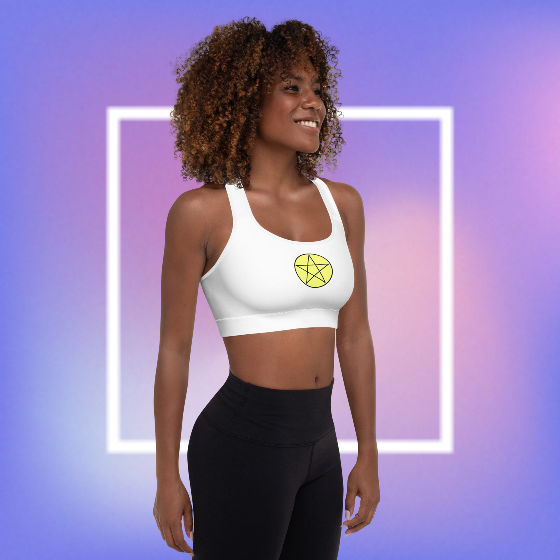 Women's white sports bra with a yellow center printed pentacle star in the front and a white angel wing and purple demon wing in the back. 