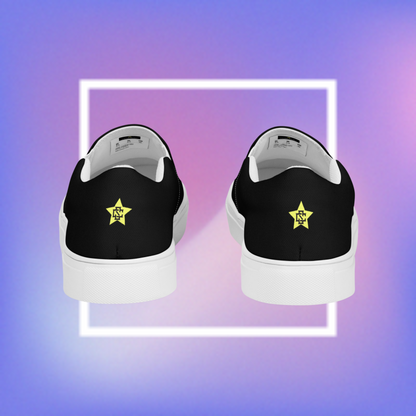 Women's black slip-ons featuring a yellow printed pentacle star in the center  tongue of the shoe and a signature star initialed CS in the center back of the shoe.  