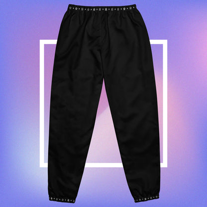 Cozmic Studioz Stellar CS Track Pants for Men. Trendy track pants with a CS initial print and a stellar pattern on the collars, showcasing Cozmic Studioz's signature style.