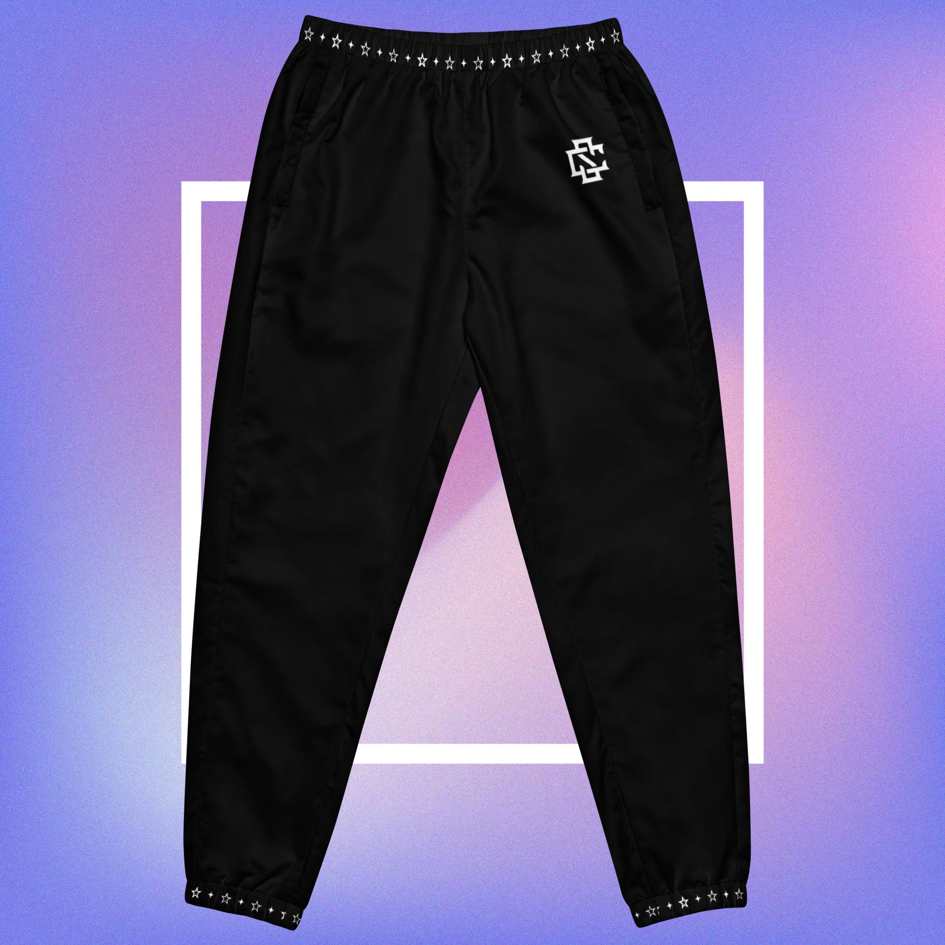 Cozmic Studioz Stellar CS Track Pants for Men. Trendy track pants with a CS initial print and a stellar pattern on the collars, showcasing Cozmic Studioz's signature style.