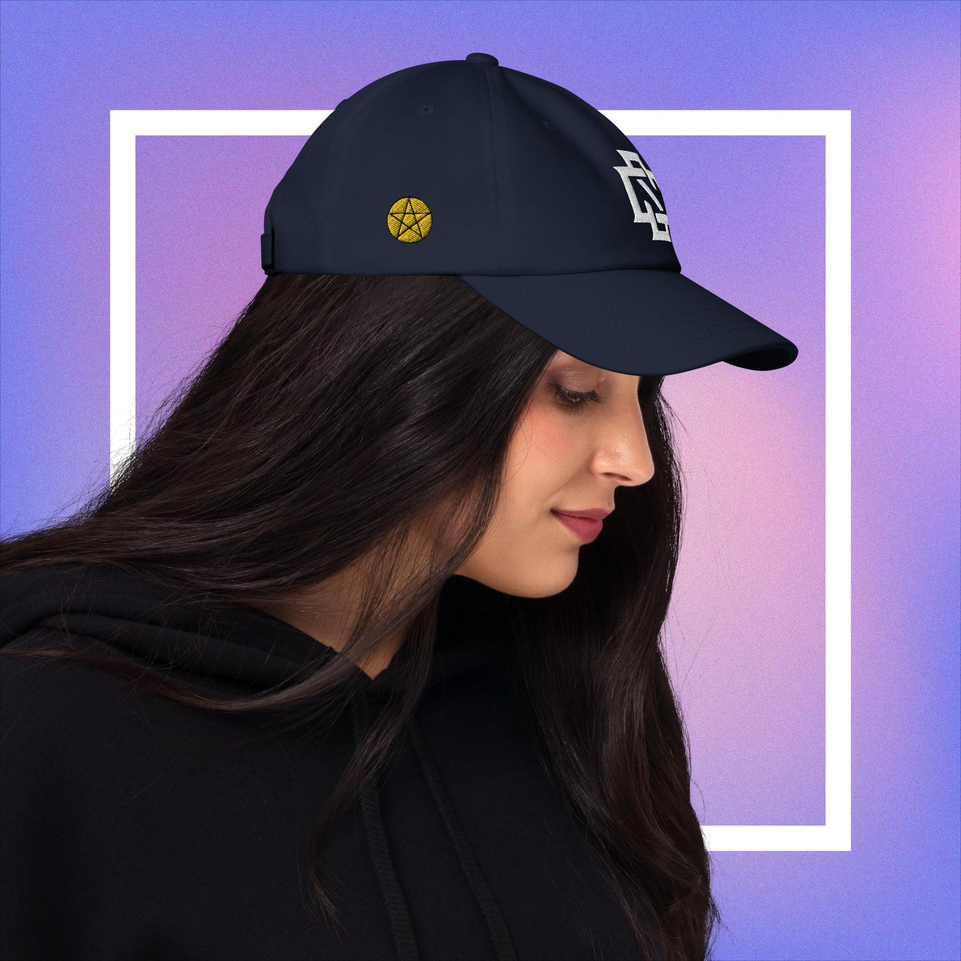 Cozmic Studioz CS Arch Cap for Women: White embroidered CS symbol centered with yellow pentacles on each side of navy blue arched cap.