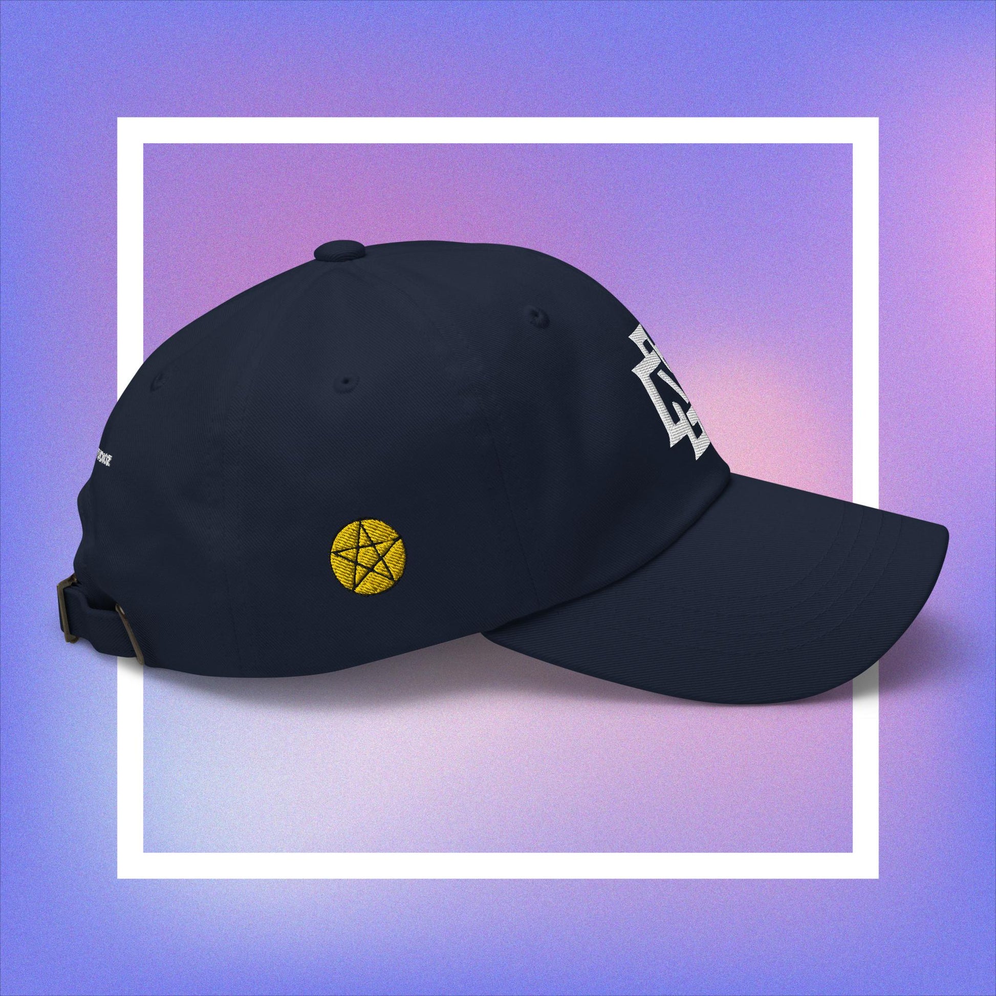 Cozmic Studioz CS Arch Cap for Women: White embroidered CS symbol centered with yellow pentacles on each side of navy blue arched cap.